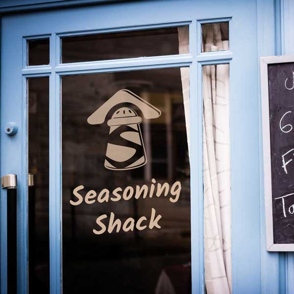 Store front entrance with chalk board showcasing daily menu